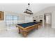 Billiard room features a pool table and a view of the home's entrance at 24343 Pirate Harbor Blvd, Punta Gorda, FL 33955