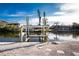 Private waterfront residence with boat lift along a canal with clear blue skies above at 24343 Pirate Harbor Blvd, Punta Gorda, FL 33955