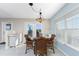 Bright dining area with a glass table, wicker chairs, and natural light from the large window at 24343 Pirate Harbor Blvd, Punta Gorda, FL 33955