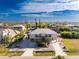 A beautiful two-story home with a metal roof, set against a stunning sky, in a waterfront neighborhood at 24343 Pirate Harbor Blvd, Punta Gorda, FL 33955