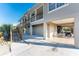 Exterior view of a coastal home featuring a two-story design, ground-level parking, and access stairs to the upper levels at 24343 Pirate Harbor Blvd, Punta Gorda, FL 33955