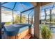 Relax in this screened-in hot tub, with views of the pool and canal at 24343 Pirate Harbor Blvd, Punta Gorda, FL 33955