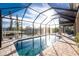 Sparkling pool under a screened enclosure overlooking a canal at 24343 Pirate Harbor Blvd, Punta Gorda, FL 33955