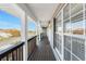 Welcoming outdoor porch with wooden floors, white pillars, and ample natural light at 24343 Pirate Harbor Blvd, Punta Gorda, FL 33955