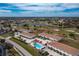 Aerial view of townhouses, pool, and surrounding area at 26376 Nadir Rd # 301, Punta Gorda, FL 33983