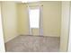 Empty carpeted bedroom with large window and neutral walls at 26376 Nadir Rd # 301, Punta Gorda, FL 33983