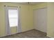 Bright bedroom with window, blinds, and double doors at 26376 Nadir Rd # 301, Punta Gorda, FL 33983