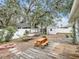 Backyard with deck, firepit, and chicken coop at 2771 Siesta Dr, Venice, FL 34293