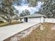 House exterior showcasing a driveway and landscaping at 2771 Siesta Dr, Venice, FL 34293