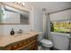 Simple bathroom with a toilet, vanity, and window at 28094 Chinquapin Dr, Punta Gorda, FL 33955