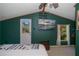 Bedroom with a large TV, wood floors, and a private door at 28094 Chinquapin Dr, Punta Gorda, FL 33955