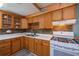 Kitchen with wood cabinets, gas range, and a tile backsplash at 28094 Chinquapin Dr, Punta Gorda, FL 33955