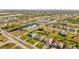 Aerial view showcases home's location on a waterway, close to canals, with nearby properties at 290 Rotonda E Blvd, Rotonda West, FL 33947