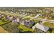 Aerial view of property highlighting the caged pool, solar panels, landscaping, and surrounding neighborhood at 290 Rotonda E Blvd, Rotonda West, FL 33947