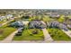 Aerial view of the property showcases lush landscaping, a well-maintained lawn, and a circular driveway at 290 Rotonda E Blvd, Rotonda West, FL 33947