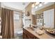 Neutral bathroom with a tub and shower, vanity with granite countertop, and framed artwork at 290 Rotonda E Blvd, Rotonda West, FL 33947