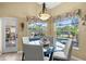 Breakfast nook featuring a glass table, four chairs, and window views of the backyard pool at 290 Rotonda E Blvd, Rotonda West, FL 33947