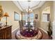 Elegant dining room with decorative chandelier, tray ceilings, a glass table, and hardwood floors at 290 Rotonda E Blvd, Rotonda West, FL 33947