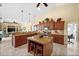 This expansive kitchen is complete with a granite-topped island with breakfast bar and custom wood cabinets at 290 Rotonda E Blvd, Rotonda West, FL 33947