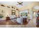 Comfortable living room featuring neutral colors, a ceiling fan, wood floors, and slider door access to pool at 290 Rotonda E Blvd, Rotonda West, FL 33947