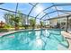 Relaxing screened-in pool area with lush landscaping, perfect for entertaining or enjoying the Florida sunshine at 290 Rotonda E Blvd, Rotonda West, FL 33947