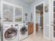 Bright laundry room with washer, dryer, and built-in cabinets at 298 Fry Se Ter, Port Charlotte, FL 33952