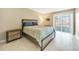 Guest bedroom with a queen-size bed and private access to patio at 311 Garvin St # 207B, Punta Gorda, FL 33950