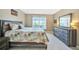 Main bedroom with king-size bed, dresser, and calming decor at 311 Garvin St # 207B, Punta Gorda, FL 33950