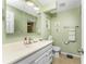 Bathroom with light green walls, white vanity, and a shower at 3183 Sulstone Dr, Punta Gorda, FL 33983