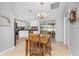 Bright dining area with wood table and chairs, adjacent to kitchen at 3183 Sulstone Dr, Punta Gorda, FL 33983