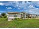 Front view of a gray house with a well-maintained lawn at 3183 Sulstone Dr, Punta Gorda, FL 33983