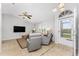 Living room with gray armchairs, beige sofa, and TV at 3183 Sulstone Dr, Punta Gorda, FL 33983