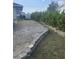 Gravel driveway and side yard with retaining wall and landscaping at 3183 Sulstone Dr, Punta Gorda, FL 33983