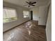 Well-lit bedroom featuring hardwood floors and window blinds at 3261 Mill Run Ct, North Port, FL 34287