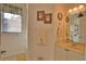 Well-lit bathroom featuring a vanity with a sink and a tiled shower at 336 Japura St, Punta Gorda, FL 33983