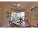 Sunlit breakfast nook with a wood table and view of the pool and backyard at 336 Japura St, Punta Gorda, FL 33983