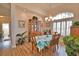 Charming dining room with wood floors, a large window with shutters and decorative china cabinet at 336 Japura St, Punta Gorda, FL 33983