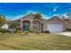 Attractive single-Gathering home with palm trees, manicured lawn, and a spacious two-car garage at 336 Japura St, Punta Gorda, FL 33983