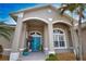 Inviting front entrance featuring double doors and a tiled porch with decorative plants at 336 Japura St, Punta Gorda, FL 33983