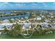 Aerial view showcasing waterfront home with private dock surrounded by lush tropical foliage at 37 Bocilla Dr, Placida, FL 33946