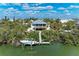 Waterfront home aerial featuring a boat dock, lush greenery, and a serene coastal setting at 37 Bocilla Dr, Placida, FL 33946