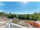 Inviting backyard with mature trees and pathway leading to the waterfront at 37 Bocilla Dr, Placida, FL 33946