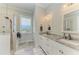 Bright bathroom with double vanity, granite countertops, and spacious walk-in shower at 37 Bocilla Dr, Placida, FL 33946