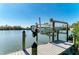 Dock featuring a boat lift and clear waterway views at 37 Bocilla Dr, Placida, FL 33946