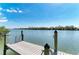 Scenic view of the dock extending into the water with waterfront homes at 37 Bocilla Dr, Placida, FL 33946