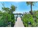 Beautiful dock leading to the water, surrounded by lush greenery at 37 Bocilla Dr, Placida, FL 33946