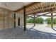 Undercover outdoor space with stone flooring and exposed beam ceiling at 37 Bocilla Dr, Placida, FL 33946