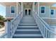 Inviting stairs leading to the double-door front entrance of this charming beach home at 37 Bocilla Dr, Placida, FL 33946