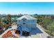 Charming coastal home with a metal roof, tidy landscaping, and a white stair entrance at 37 Bocilla Dr, Placida, FL 33946