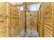 Private outdoor shower featuring wood paneling and stone flooring at 37 Bocilla Dr, Placida, FL 33946